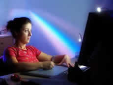 A photo of a girl searching on computer